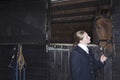 Female Horseback Rider With Horse In Stable Royalty Free Stock Photo