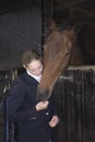 Female Horseback Rider With Horse In Stable Royalty Free Stock Photo