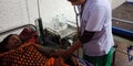 Female hospital staff checking woman patient in bad at hospital