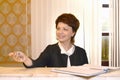 A female hotel administrator gives a visitor the keys to a hotel room