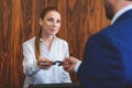 Female hotel manager welcoming businessman