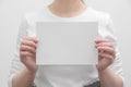 female HR manager offers job by showing you blank paper mockup for your promotional content
