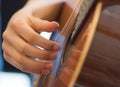 Female human hand playing an accoustic guitar strumming the strings Royalty Free Stock Photo