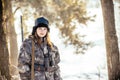 Female hunter in camouflage clothes ready to hunt, holding gun a Royalty Free Stock Photo