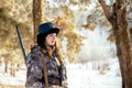 Female hunter in camouflage clothes ready to hunt, holding gun a Royalty Free Stock Photo