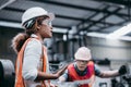 Female industrial engineer wearing a white helmet while