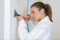 female industrial painting apprentice scraping wall