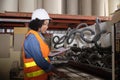 A female industrial worker checks the machine in a paper manufacturing factory Royalty Free Stock Photo