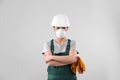 Female industrial worker in uniform on light background Royalty Free Stock Photo