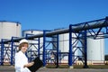 Female inpector performing an audit of tank farm Royalty Free Stock Photo
