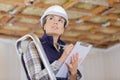 female inspector with clipboard inside renovation property