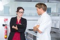 Female inspector in restaurant kitchen with chef