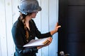 Female inspector reviews a room door Royalty Free Stock Photo