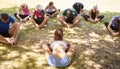 Female Instructor Leading Outdoor Yoga Class Royalty Free Stock Photo