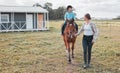 Horse riding has always been something I wanted to do. a female instructor taking a little girl horse riding. Royalty Free Stock Photo