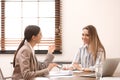 Female insurance agent consulting young woman
