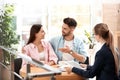 Female insurance agent working with young couple