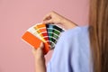 Female interior designer with palette samples on color background Royalty Free Stock Photo