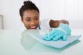 Female Janitor Cleaning Desk Royalty Free Stock Photo