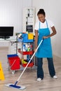 Female Worker Cleaning Floor In Office Royalty Free Stock Photo