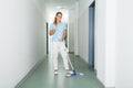 Female Janitor Cleaning The Floor With Mop Royalty Free Stock Photo