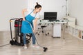 Female Janitor Cleaning Floor With Vacuum Cleaner Royalty Free Stock Photo