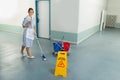 Female janitor cleaning floor