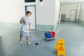 Female janitor cleaning floor Royalty Free Stock Photo