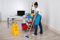 Female Janitor Mopping Floor In Office Royalty Free Stock Photo