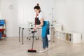 Female Janitor Sweeping Floor With Broom Royalty Free Stock Photo