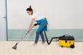 Female Janitor Vacuuming Floor Royalty Free Stock Photo