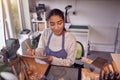 Female Jeweller Looking At Ring Design On Digital Tablet In Studio