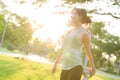 Female jogger. Fit young Asian woman with green sportswear stretching muscle in park before running and enjoying a healthy outdoor Royalty Free Stock Photo