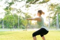 Female jogger. Fit young Asian woman with green sportswear stretching muscle in park before running and enjoying a healthy outdoor Royalty Free Stock Photo