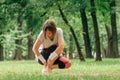 Female jogger with painful ankle injury during park jogging activity Royalty Free Stock Photo