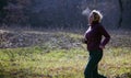 Female jogger running at cold morning rising breath vapour Royalty Free Stock Photo