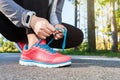 Female jogger tying her shoes Royalty Free Stock Photo