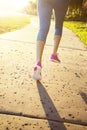 Female jogging in a city park view from behind Royalty Free Stock Photo