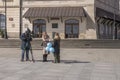 Female journalist of independent tvn24, a Polish news television interviewing a woman holding blue balloon on Castle square.