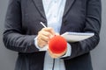 Female journalist at media event or news conference, writing notes, holding microphone Royalty Free Stock Photo