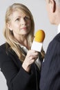 Female Journalist With Microphone Interviewing Businessman Royalty Free Stock Photo