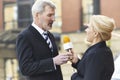 Female Journalist With Microphone Interviewing Businessman