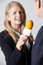 Female Journalist With Microphone Interviewing Businessman Royalty Free Stock Photo