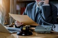 Female judge in a courtroom with the gavel, working with, computer and docking keyboard, eyeglasses, on table. Royalty Free Stock Photo