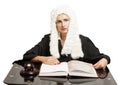 Female judge wearing a wig and black mantle with judge gavel and Royalty Free Stock Photo