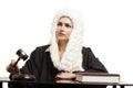 Female judge wearing a wig and black mantle with judge gavel and Royalty Free Stock Photo