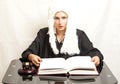 Female judge wearing a wig and black mantle with judge gavel an Royalty Free Stock Photo