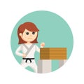 Female karate standing and crushing wood