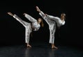 Female karatekas in kimono, combat stance Royalty Free Stock Photo