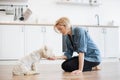 Female keeper giving treat for command during home workout